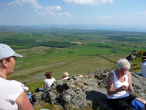6.Llangybi, Bronmiod, Pen y Gaer, three hills and a ffynnon.
27/5/12. Our thrid and final summit. Pen-y-Gaer. We are definitely feeling the effects of the heat and the climb. Moel y Gest and the mountains to the east of Harlech: Diffwys, Moel Ysgyfarnogod, Craig Wion and the Rhinogs .
Keywords: May12 Sunday Catrin Williams Noel Davey