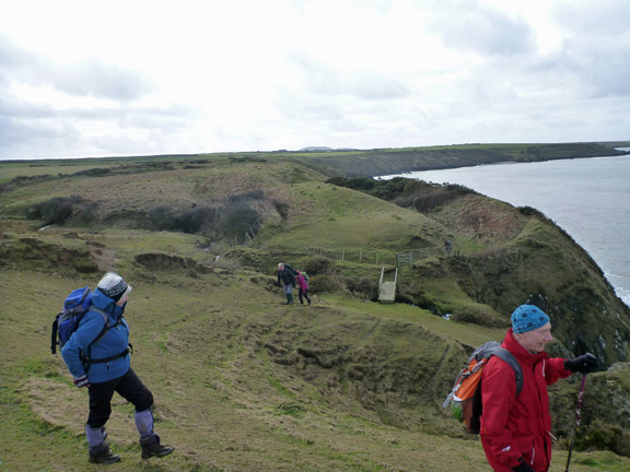 6.Porth Oer to Porth Ysgaden
16/2/14. At Porth Ty Mawr with our lunch site in the background. One of our number is reluctant to leave such a comfortable spot.
Keywords: Feb14 Sunday Hugh Evans