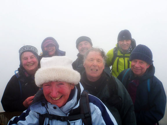 3.Snowdon
6/1/13. On top of Snowdon. The top of the trig point can be seen bottom left. Wind 45mph. Wind Chill -6.5ºC which is why the smiles are rather fixed. It was quite busy up there.
Keywords: Jan13 Sunday Noel Davey
