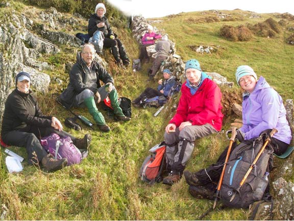 3.Pystyll & Moel Gwynus 
8/12/13. Lunch-time after 4.5miles not far from Bwlch. Two photographs have been combined to get everybody in. Photo: Dafydd Williams.
Keywords: Dec13 Sunday Catrin Williams