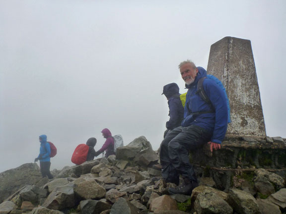 4.Cader Idris
9/9/18. Our walk leader takes a break at the summit in a combination of wind (40mph gusts) and rain. That is not a smile on his face. The rest of the group is heading for the nearby roofed shelter.
Keywords: Sep18 Sunday Noel Davey