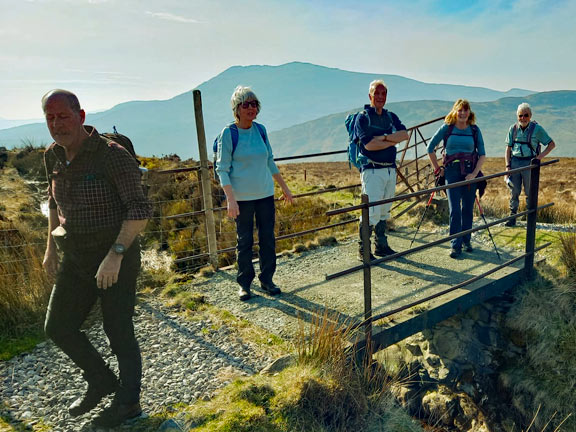 3. Capel Curig - Pen Llithrig y Wrach - Pen yr Helgi Du
9/3/25. Crossing the leat which is 350 yds from Maen Trichwmwd, near our coffee stop and the base of the first  climb. Photo: Eryl Thomas.
Keywords: Mar25 Sunday Eryl Thomas