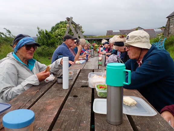 7. Clynnog Fawr - Caeau Tanybwlch - Henbant-bâch
18/6/26. Picnic lunch at Henbant-bâch. There were enough tables for almost all of us to eat together. It looked like rain but we were lucky. It held off. Some of us headed to the cafe straight away for coffee and cake. They were not disappointed.
Keywords: Jun26 Thursday Jane Logan