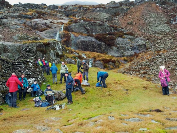 4. Gallt y Wenallt
22/02/26. Morning paned (morning break for tea/coffee/soup) at the copper mine at about 1450ft. The mine was highly productive in the early Victorian era, with ore transported to Porthmadog, Swansea, and Liverpool for smelting. The site features old mining tips, and remnants of the old tramway, which can be followed to the mine. Photo: Eryl Thomas.
Keywords: Feb26 Sunday Noel Davey