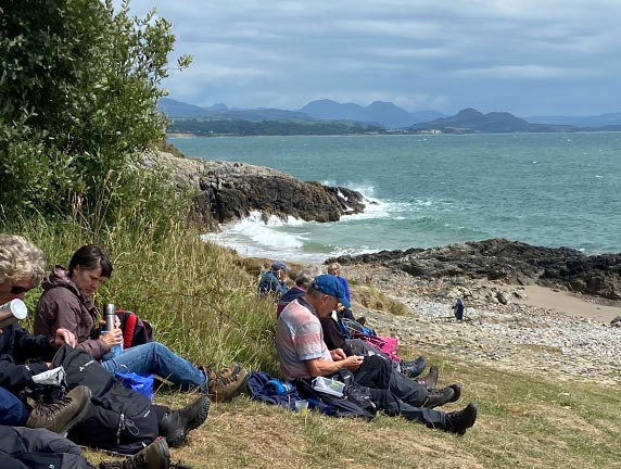 7.Tyn Morfa - Penychain - 'Hafan-y-Mor' 
6/7/23. Photo: Nia Parry. Lunch looking out from Porth Fechan towards Porthmadog with Moel-y-Gest and the Moelwyns in the background.
Keywords: Jul23 Thursday Nia Parry