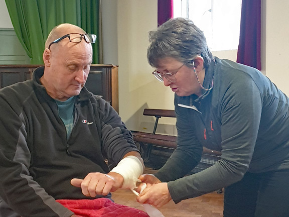 2.Basic First Aid Course - Efailnewydd Chapel Vestry
22/11/23.  A demonstration of bandaging  by the instructor. Liberal amounts of saws coch were used to add a bit of realism.
Keywords: Nov23 Wednesday Hugh Evans