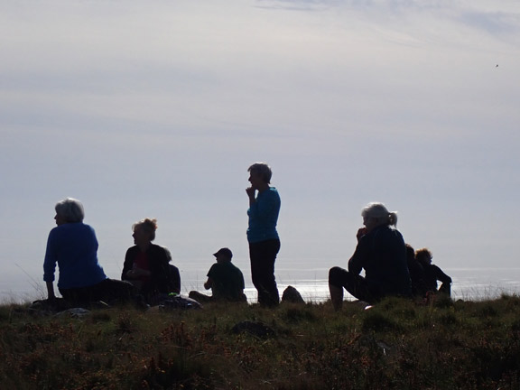 5.Bryncir-Mynydd Cennin
12/10/23. Lunch on the top of Mynydd Cennin. Brilliant views.. Our group silhouetted against the sparkling sea of Tremadog Bay. 
Keywords: Oct23 Thursday Kath Mair