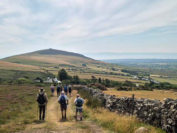 3. Carnguwch
16/7/26. Still alongside ‘Y Wal Fawr’. The small lump of a hill which is Carnguwch can be seen ahead of us. Photo: Debby Cheng.
Keywords: Jul26 Thursday Christine Evans
