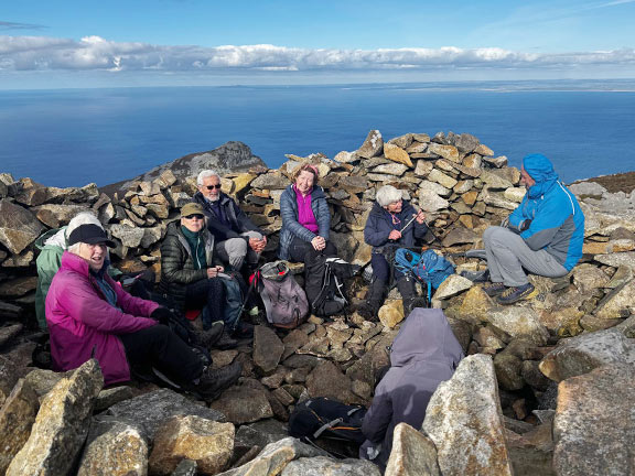 9. Three Peaks of Yr Eifl
18/10/26. Finally lunch at the summit of Tre'r Ceiri (our third peak). There was some shelter from the chilling breeze. Looking north over Caernarfon Bay. Photo: Sally Kettle.
Keywords: Oct26 Sunday Gareth Hughes